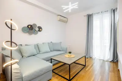 a living room with a couch and a table at Apartments Historical Center in Athens