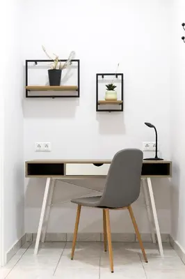 a desk with a chair and two pictures on the wall at Apartments Historical Center in Athens