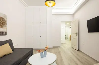 a living room with a couch and a table at Apartments Historical Center in Athens
