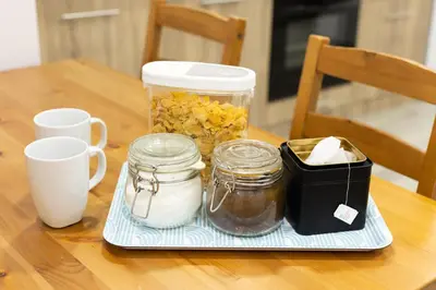 a table with two mason jars and a tray of food at Apartments Historical Center in Athens