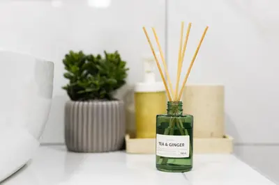 a green bottle with reeds in it on a counter at Apartments Historical Center in Athens