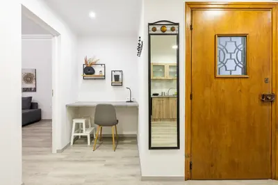 a door leading into a kitchen with a table and a chair at Apartments Historical Center in Athens