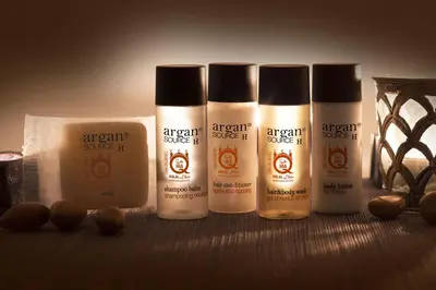 a group of four bottles of ayurvedic cosmetics on a table at Acropolis Suite in Athens