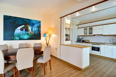 a kitchen and dining room with a table and chairs at Villa Filoxenia all seasons, near airport, sea, Athens in Aghia Marina
