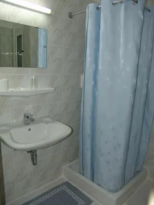 a bathroom with a sink and a shower at Hotel Cosmos in Athens