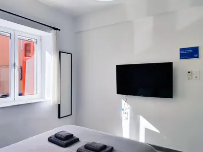 a bedroom with a bed with two towels on it at KYMA Apartments - Athens Acropolis 2 in Athens