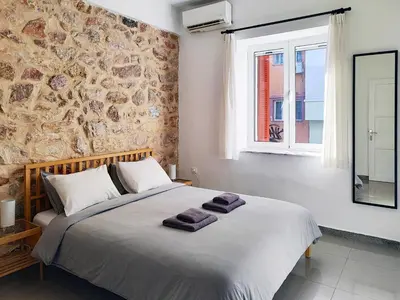 a bedroom with a large bed with towels on it at KYMA Apartments - Athens Acropolis 2 in Athens