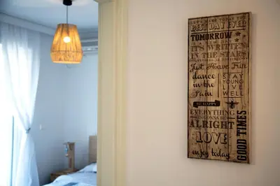 a bedroom with a poster on the wall at Boutique52 Luxury Apartments in Athens