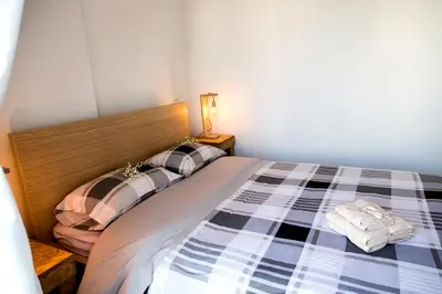 a bedroom with a bed with a checkered blanket at Boutique52 Luxury Apartments in Athens