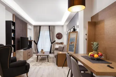 a living room with a table and a dining room at Acropolis Elegant Apartment in Athens