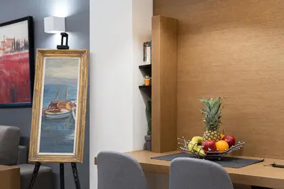 a table with a bowl of fruit and a mirror at Acropolis Elegant Apartment in Athens