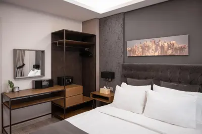 a bedroom with a bed and a desk and a mirror at Acropolis Elegant Apartment in Athens