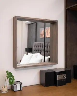 a mirror on a wall with a bed in a room at Acropolis Elegant Apartment in Athens