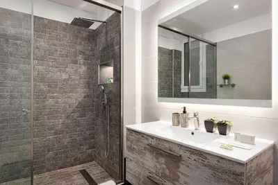 a bathroom with a sink and a shower with a mirror at Acropolis Elegant Apartment in Athens
