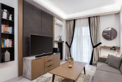 a living room with a tv and a couch at Acropolis Elegant Apartment in Athens