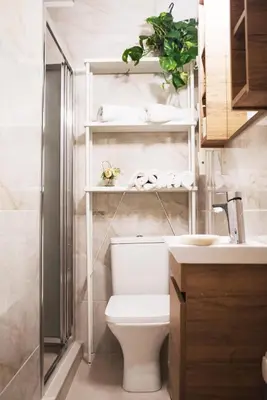 a bathroom with a white toilet and a sink at Rastoni Athens Suites near Acropolis in Athens