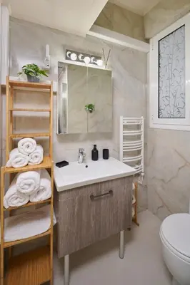 a bathroom with a sink and a toilet at Rastoni Athens Suites near Acropolis in Athens