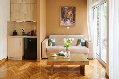 a living room with a couch and a coffee table at Rastoni Athens Suites near Acropolis in Athens