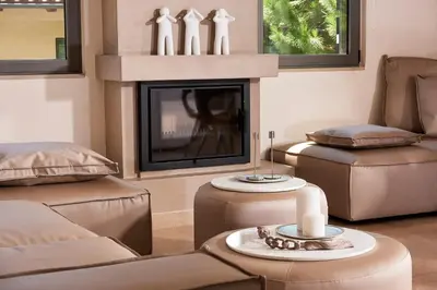 a living room with a fireplace and chairs and a couch at Grystal Green Properites in Athens