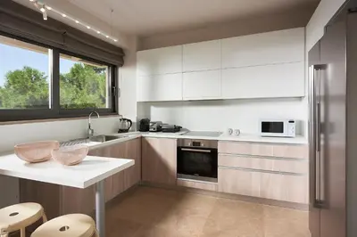 a kitchen with white cabinets and a white counter top at Grystal Green Properites in Athens