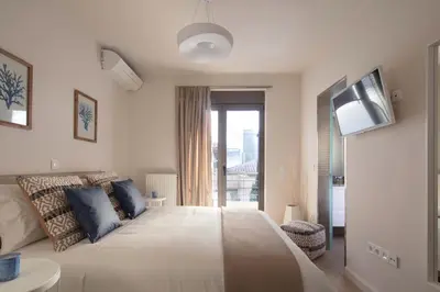 a bedroom with a large bed and a tv at Grystal Green Properites in Athens