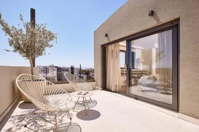 two chairs and a table on a balcony at Grystal Green Properites in Athens