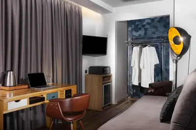 a room with a desk with a laptop on it at 360Degrees Pop Art Hotel in Athens