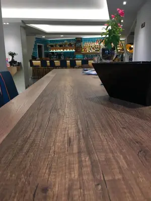a long wooden table in a room with chairs at 360Degrees Pop Art Hotel in Athens