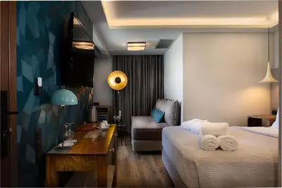 a hotel room with two beds and a table and a desk at 360Degrees Pop Art Hotel in Athens