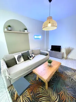 a living room with a couch and a coffee table at Anastasias house near Athens airport in Spáta