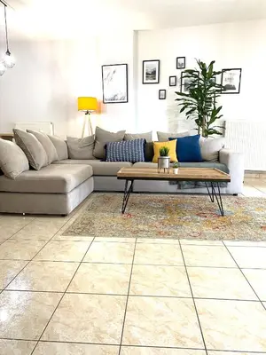 a living room with a couch and a coffee table at Anastasias house near Athens airport in Spáta