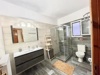 a bathroom with a sink and a shower and a toilet at Anastasias house near Athens airport in Spáta