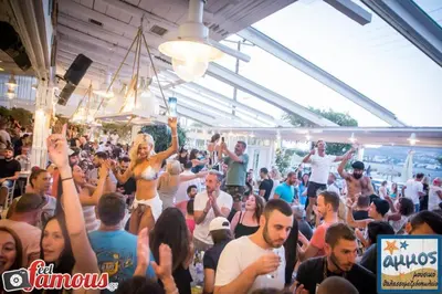 a crowd of people standing in a crowd at a party at 4 Seasons Suites Paradise Near Airport And Beach in Markopoulo