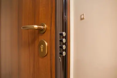 a wooden door with a brass door handle at Elegant and Safe Gold and Blue Apartment walk to Acropolis in Athens