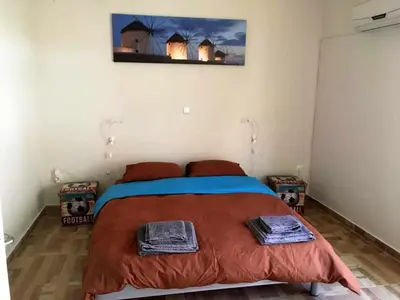 a bedroom with a bed with two towels on it at Biophylic - 3bdr apartment in Athens