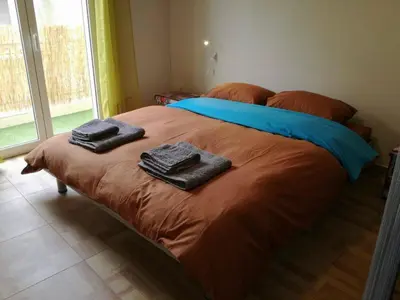 a bed with two towels sitting on top of it at Biophylic - 3bdr apartment in Athens