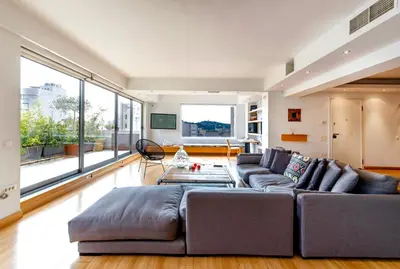 a living room with a couch and a large window at 5* 