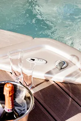 a swimming pool with two glasses and a bottle of champagne at 5* 