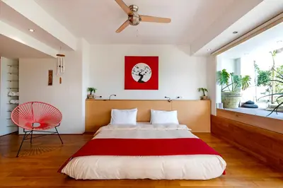 a bedroom with a large bed and a fan at 5* 