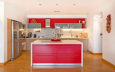 a kitchen with red cabinets and a white counter top at 5* 