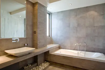 a bathroom with a sink and a tub and a mirror at 5* 