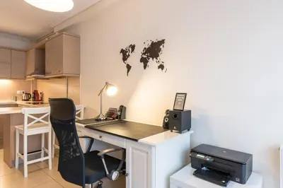 an office with a desk and a printer on a wall at Patissia Apartment in Athens