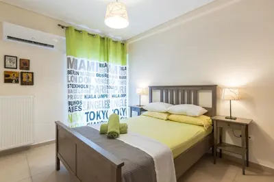 a bedroom with a bed and a green curtain at Patissia Apartment in Athens
