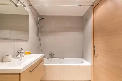 a bathroom with a sink and a bath tub at Patissia Apartment in Athens