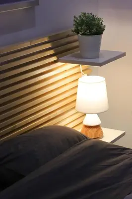 a bedroom with a bed with a lamp and a plant at Luxury Apartment near Acropolis in Athens