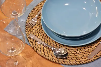 a table with a plate and spoon and wine glasses at Luxury Apartment near Acropolis in Athens