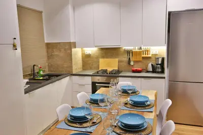 a kitchen with a table with blue dishes on it at Luxury Apartment near Acropolis in Athens