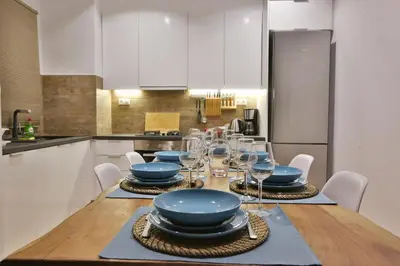 a dining room with a table with plates and wine glasses at Luxury Apartment near Acropolis in Athens