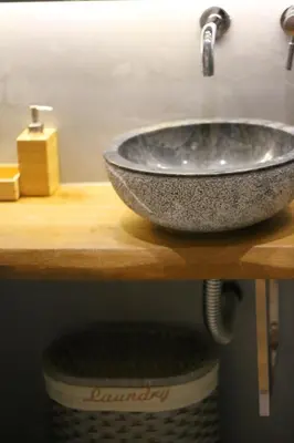 a bathroom sink on a wooden counter top with a sink at Luxury Apartment near Acropolis in Athens