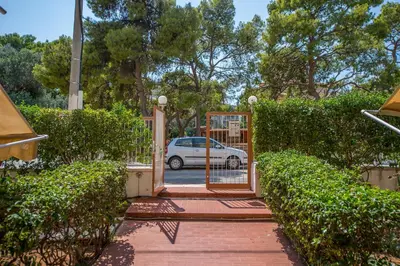a gate to a driveway with a car in a parking lot at Starapartment Athens-Varkiza Top 1 in Varkiza